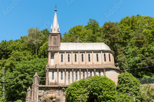 Reproduction of the cave of Lourdes and the Sanctuary in front of Abbey in Ganna, Valganna, province of Varese, Italy photo