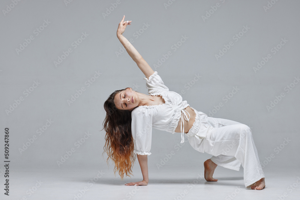 Beautiful young modern dancer or fitness dancer on a white isolated background Beautiful young modern dancer or fitness dancer on a white isolated background