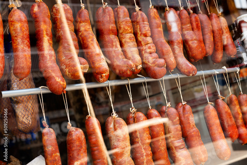 Dry cured traditional spanish sausage hanging in a store