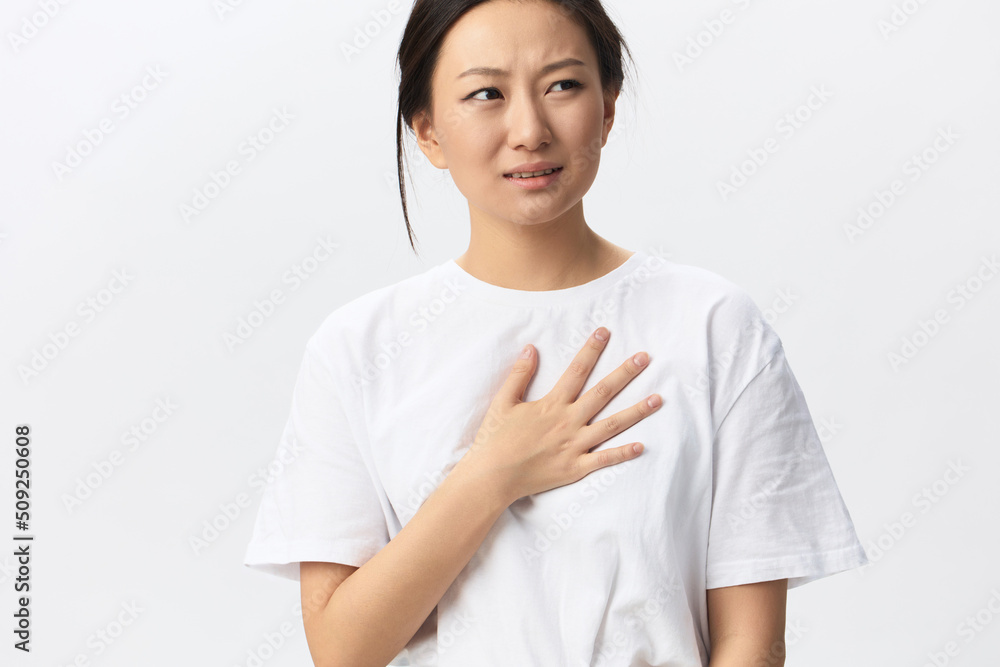 Heart attack. Suffering from pain tanned beautiful young Asian woman hold hand on chest heart crying posing isolated on white background. Injuries Poor health Illness concept. Cool offer Banner Heart attack. Suffering from pain tanned beautiful young Asian woman hold hand on chest heart crying posing isolated on white background. Injuries Poor health Illness concept. Cool offer Banner