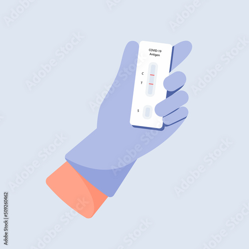 Doctor in glove holding antigen test kit