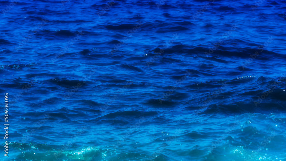Sea water texture. Deep blue abstract background. Ocean water surface