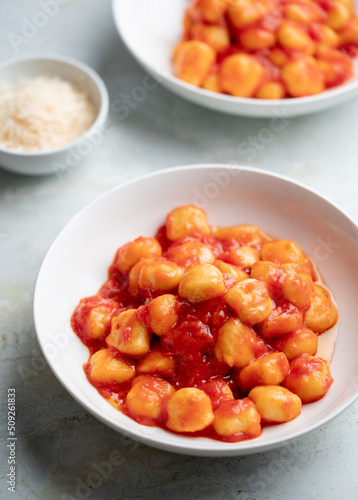 Gnocchi with tomato sauce and parmigiano on a plate