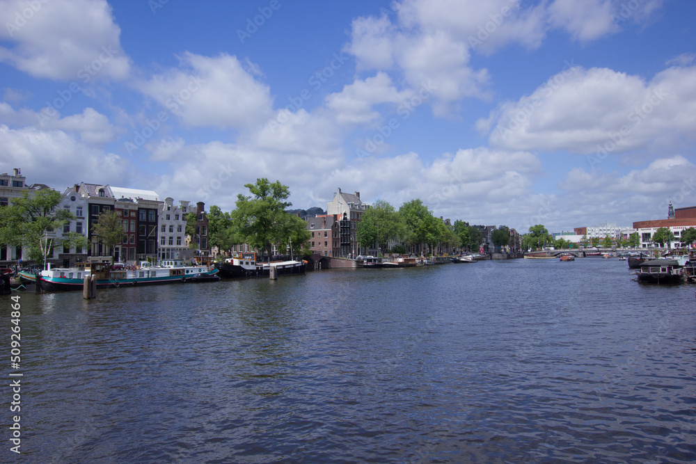 Gracht (town canal) in the city of Amsterdam on a sunny day