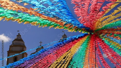 decoração de festa junina no brasil com bandeirinhas coloridas em frente a igreja photo