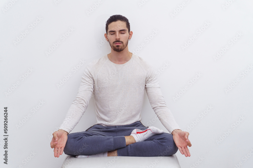 Man on a white background meditating Man on a white background meditating