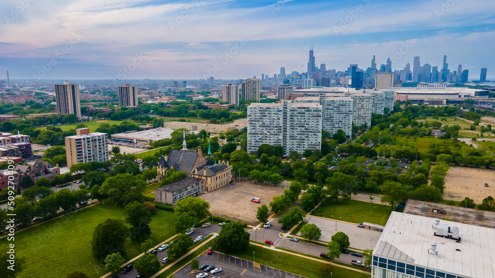 Chicago, IL USA June 5th 2022: Aerial drone view of a Chicago neighborhood downtown. the city beautiful architectural is also covered by lush green trees throughout the urban cityscape