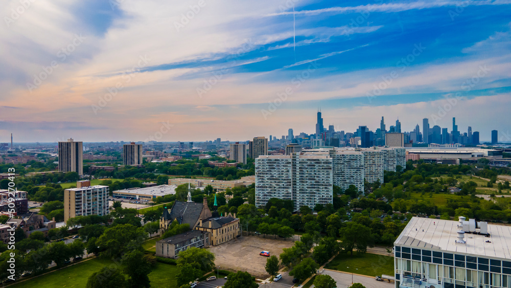 Chicago, IL USA June 5th 2022: Aerial drone view of a Chicago neighborhood downtown. the city beautiful architectural is also covered by lush green trees throughout the urban cityscape