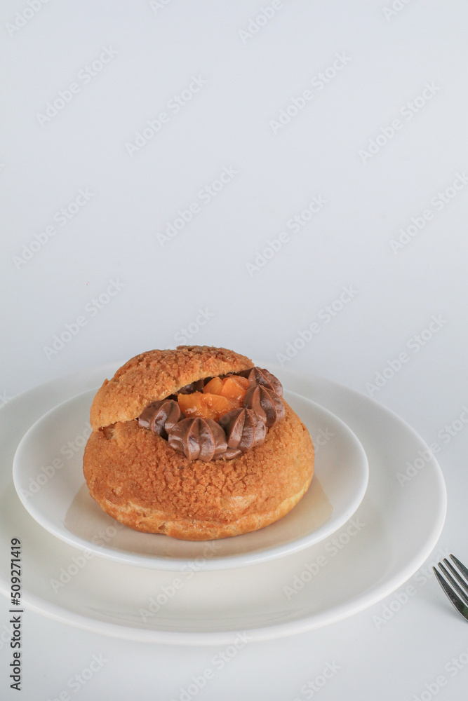 Delicious homemade choux pastry with custard and Marian Plum or Mayongchid. on white background Delicious homemade choux pastry with custard and Marian Plum or Mayongchid. on white background