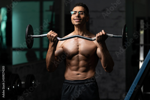 Man With Gynecomastia Problem Working Out Biceps