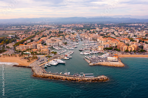 Scenic aerial panoramic view of modern Frejus cityscape on Mediterranean coast with sandy beach and marina on summer day, Var department, France © JackF