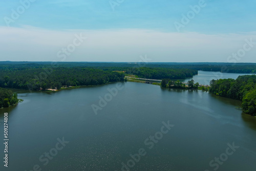 breathtaking aerial shot of the vast blue waters of Lake Acworth surrounded by miles of lush green trees with blue sky at Cauble Park in Acworth Georgia USA photo