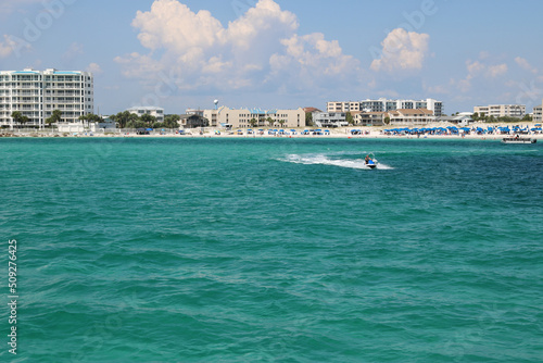 speedboat moving quickly through the ocean along the coastline