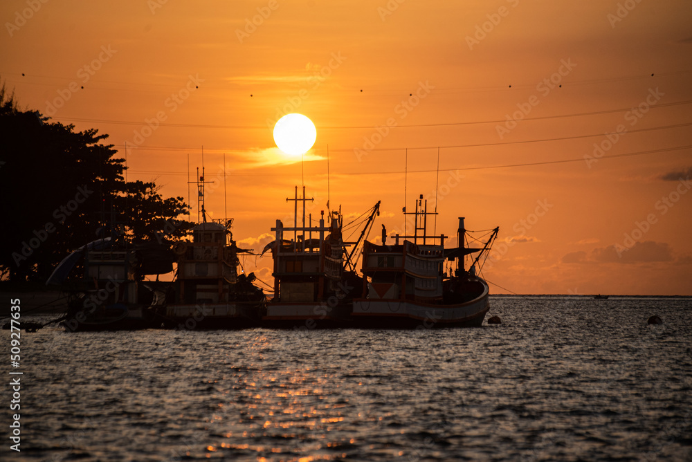 Beautiful warm sunset on the sea with fish boat. Beautiful scenery