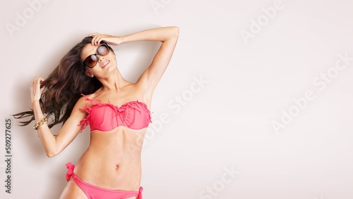 High fashion portrait of young beautiful sexy woman. Carefree model wearing lingerie swimwear bathing suit
