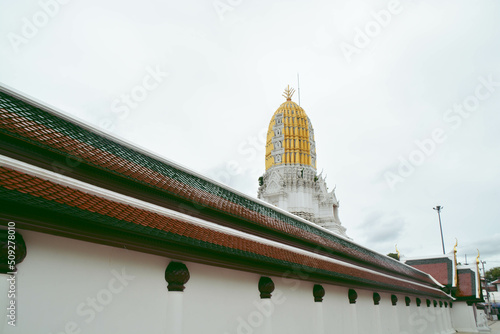 White wall side of Wat Phra Sri Rattana Mahathat (Wat Yai) and have view of Phar Prang behind the wall. photo