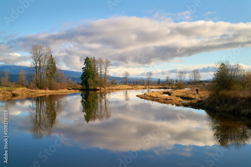 Alouette River Tranquil Cloud Reflections. Tranquil reflections along the Alouette River from the dyke trails on both sides. Pitt Meadows.