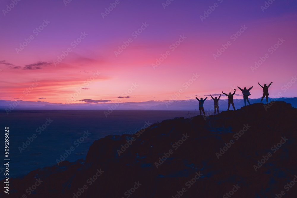Group Friends tourists stay mountain top and looking sunset. Concept travel trip friendship