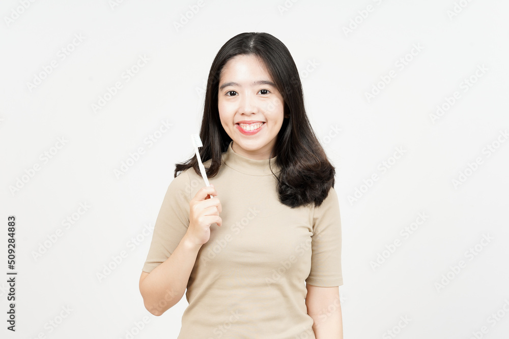 Holding toothbrush and smiling to camera Of Beautiful Asian Woman Isolated On White Background Holding toothbrush and smiling to camera Of Beautiful Asian Woman Isolated On White Background