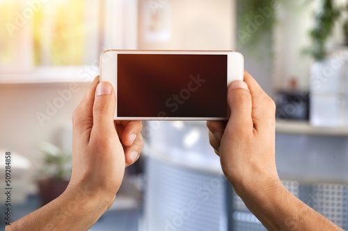 Mobile Mockup. Unrecognizable person Holding Blank Smartphone With Screen