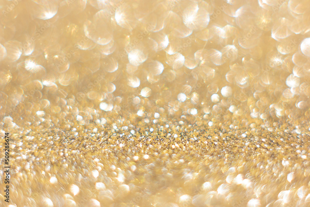 Defocused abstract colorful twinkle light background. Gold glittery bright shimmering background use as a design backdrop. Defocused abstract colorful twinkle light background. Gold glittery bright shimmering background use as a design backdrop.