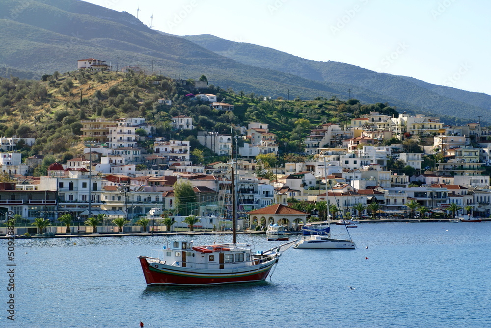 The town on Poros, Greece, with boats moored in the gulf below