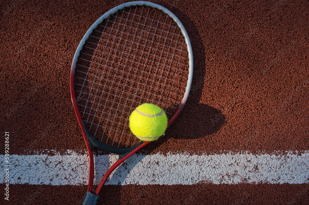 Tennis ball, racquet on hard court surface