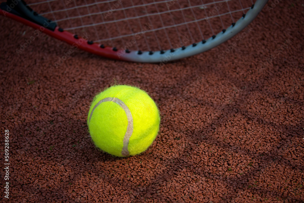 Shadow of net and racket surrounding a tennis ball