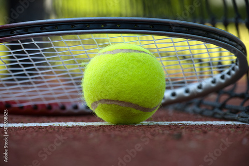 Tennis rocket over tennis ball in low angle view © NetPix