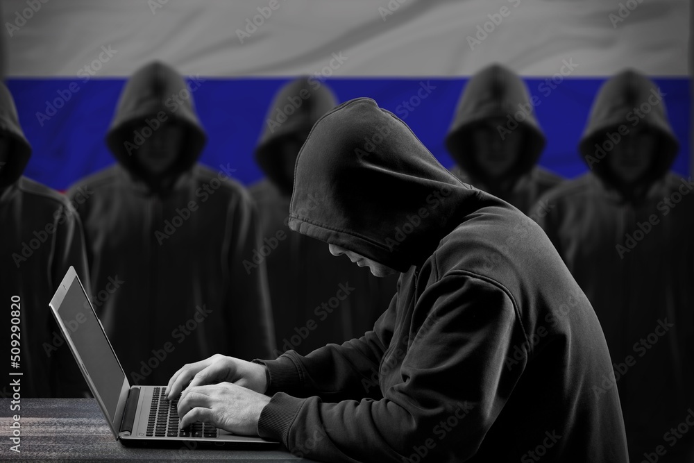 Many russian hackers in troll farm. Cyber crime and security concept. Flag in background. Many russian hackers in troll farm. Cyber crime and security concept. Flag in background.