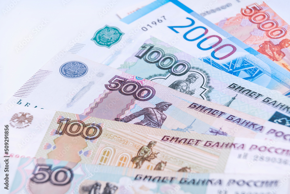 Russian money, banknotes of various denominations lie in a fan, soft focus Russian money, banknotes of various denominations lie in a fan, soft focus