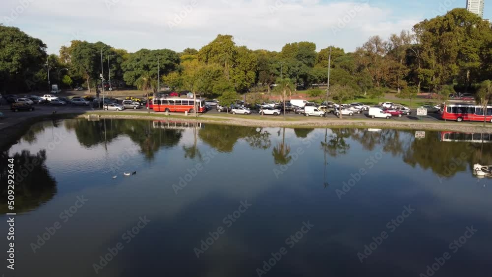 Drone flying over lake in Palermo Park at Buenos Aires, Argentina. Aerial forward descending Drone flying over lake in Palermo Park at Buenos Aires, Argentina. Aerial forward descending