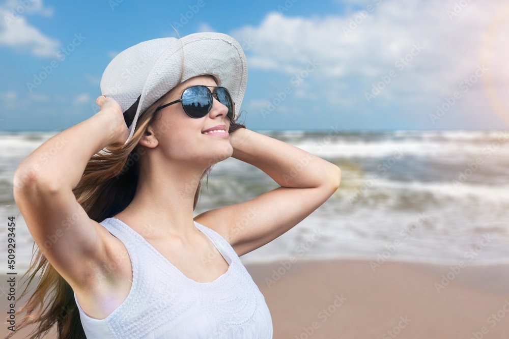 Portrait of happy young woman relaxing on tropical beach Portrait of happy young woman relaxing on tropical beach