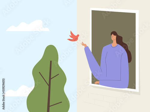 Woman looks out the window