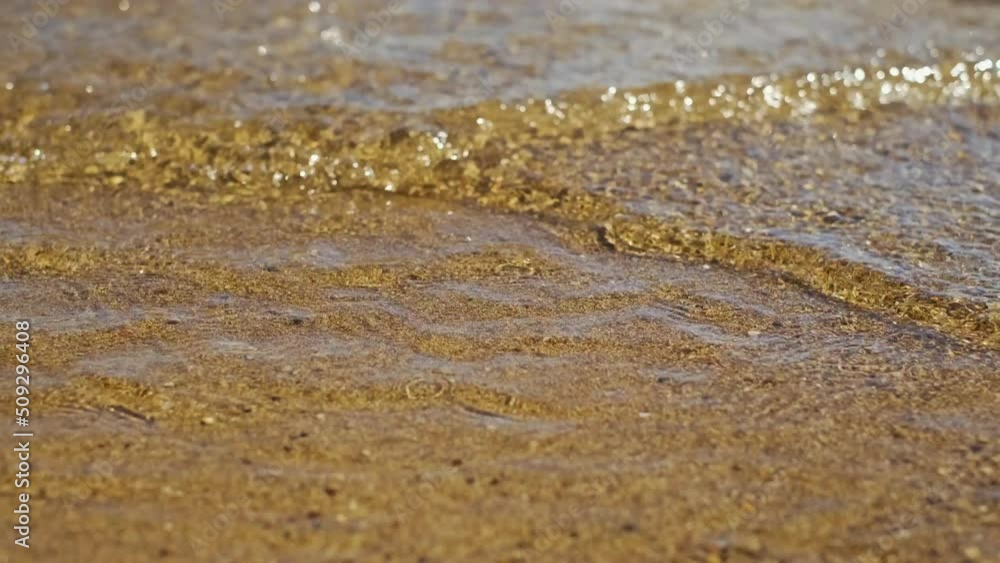 Beautiful landscape, a wave runs on the sandy shore of the sea, close-up. High quality 4k footage Beautiful landscape, a wave runs on the sandy shore of the sea, close-up. High quality 4k footage