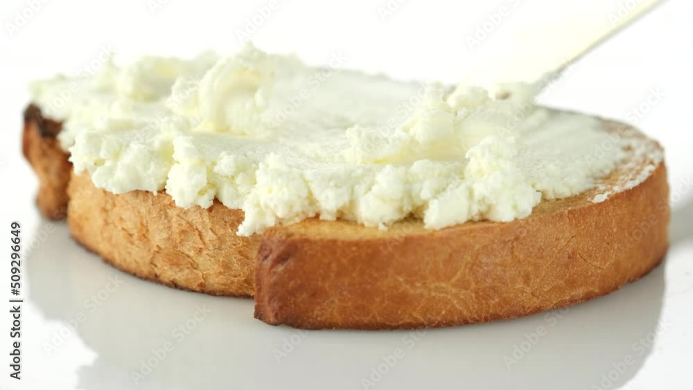 Spreading cream cheese On Bread with knife, close up Spreading cream cheese On Bread with knife, close up