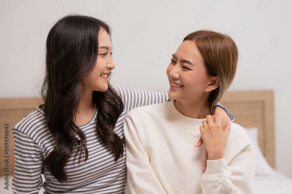 Happy LGBT lesbian couple lesbian embracing and looking together with love and romance on bed. Happy LGBT lesbian couple lesbian embracing and looking together with love and romance on bed.