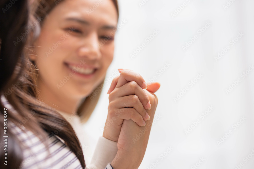 Close up hand of two female holding hands two girls sitting on bed hand by hand - same-sex lesbian couple and female friendship and love. Close up hand of two female holding hands two girls sitting on bed hand by hand - same-sex lesbian couple and female friendship and love.