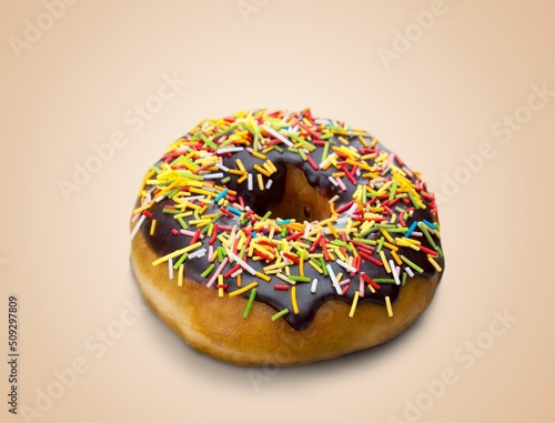 Tasty sweet chocolate glazed donut with crumbs and creme filled