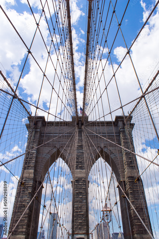 Fototapeta premium The Brooklyn bridge and the American flag, New York City. USA.