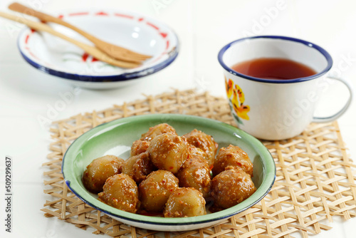 Cilok or Aci Dicolok, Traditional Street Food from West Java, Made from Tapioca or Aci Flour. Cilok is a Round Shaped Snack with a Chewy Texture, Served with Peanut Sauce photo