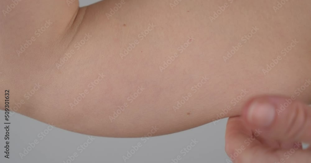 Person touching fat, weak biceps and feel bad about himself, close up view Person touching fat, weak biceps and feel bad about himself, close up view