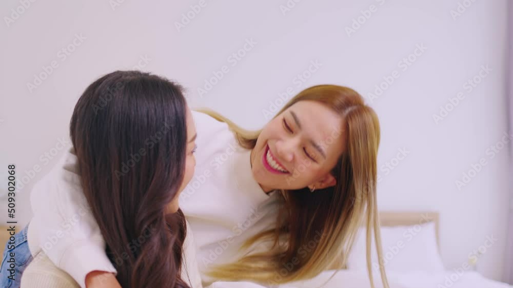 Homosexual lesbian couple talking sit on bed at home.Concept of relationships, LGBT and communication Homosexual lesbian couple talking sit on bed at home.Concept of relationships, LGBT and communication