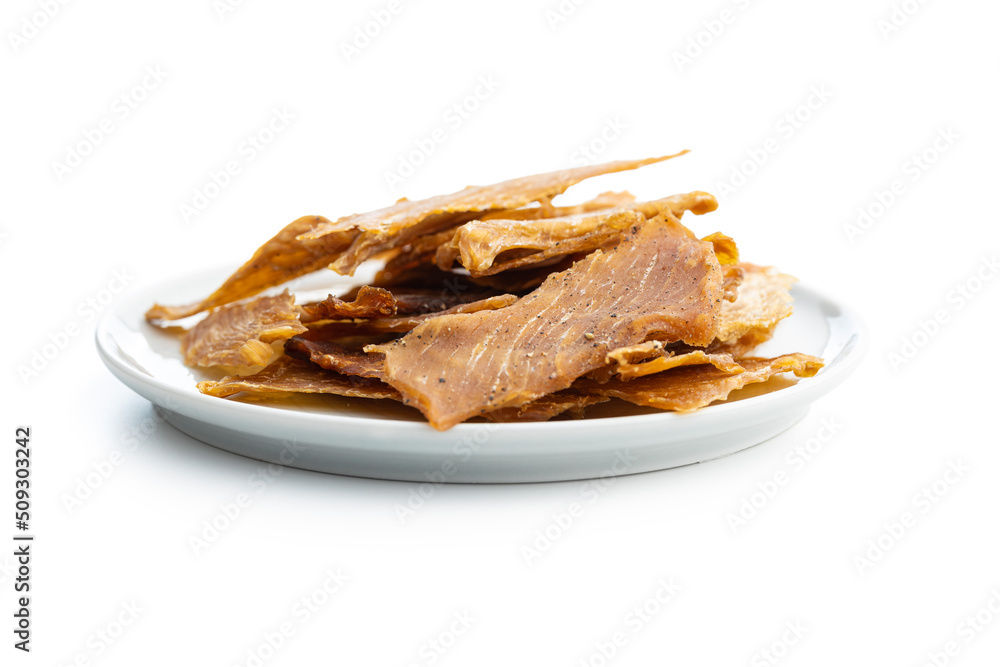 Turkey jerky meat on plate. Dried sliced meat isolated on white background. Turkey jerky meat on plate. Dried sliced meat isolated on white background.