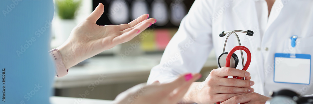 Close-up of therapist hands holding stethoscope. Close-up of therapist hands holding stethoscope.