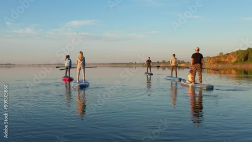 Wallpaper Mural people on sap board lift oars at same time Torontodigital.ca