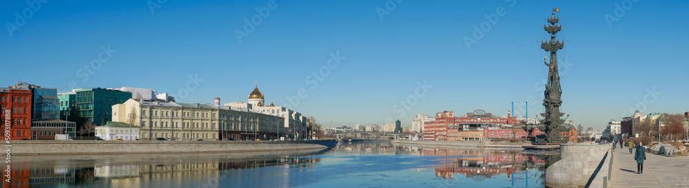 Moscow, Russia - March 01, 2022: Beautiful panoramic view of the embankment of the Muzeon Park against the blue sky. People walk along the Moscow River on a sunny spring day