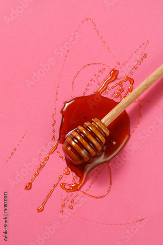 Honey dipper on pink background - Top view