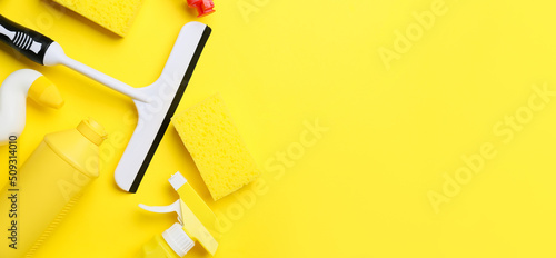 Set of cleaning supplies on yellow background with space for text