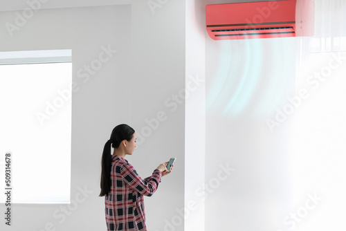 Young Asian woman with mobi...